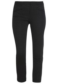 Pantalon noir à pois blancs, avec un design ajusté, des poches à l'avant et une texture lisse. Coupe droite, style décontracté.