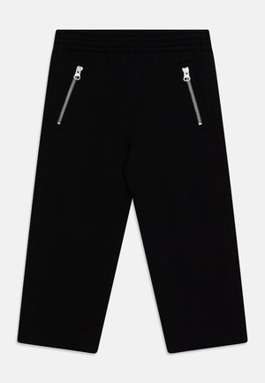Schwarze Hose aus weichem Stoff mit einem dehnbaren Bund und zwei Reißverschlusstaschen vorne. Gerades Beindesign.