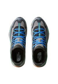 Gray athletic shoes with mesh upper, blue and green accents, contrasting laces, and textured sole pattern. Branding visible inside.