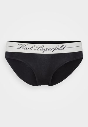 Culottes noires pour femmes avec une ceinture élastique blanche portant "Karl Lagerfeld" en lettres cursives. Tissu doux, design classique.
