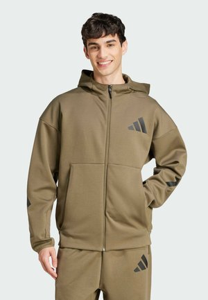 Olive green zip-up hoodie, featuring a front pocket, a drawstring hood, and black accent stripes on sleeves. Soft, textured fabric.