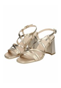 Gold metallic heeled sandals with crisscross straps, open toe, and a block heel. Smooth texture with adjustable ankle buckle.