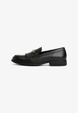 Black leather loafer with fringe detail and gold chain embellishment, low heel, and rounded toe, shown from side view on white background.