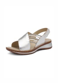 Silver leather open-toe sandal with elastic side straps, tan cushioned insole, and textured brown sole with low wedge heel.