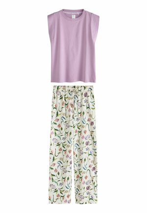 Ujjatlan lila felső, fehér nadrággal párosítva, amely színes virágmintával és rugalmas derékpánttal rendelkezik.