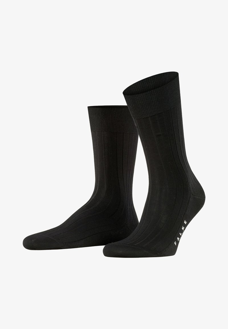 Chaussettes noires à côtes en tissu doux, dotées d'une partie supérieure bordée et d'une texture lisse, avec le logo "FALKE" au niveau de la cheville.