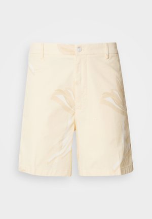 Šviesiai gelsvų medvilninių šortų su gėlių raštu. Yra mygtukų užsegimas, priekinės kišenės ir tiesus kirpimas su apdailos kraštais.