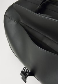 Black faux leather bag featuring a smooth texture, subtle stitching, an external pocket, and a distinct hardware clasp.