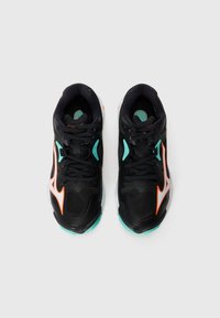Black athletic shoes with a textured upper, neon orange and teal accents, thick white sole, and black laces. Designed for sports and movement.