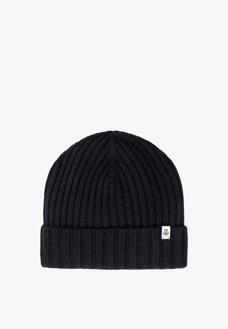 Black ribbed knit beanie with folded cuff and small white fabric tag on the cuff's right side.