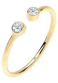 Gul cuff ring med to runde klare sten i hver ende, glat overflade, poleret finish og gravering med "375" for guldrenhed.