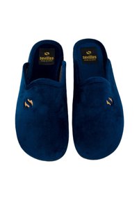 Zapatillas de casa de ante azul con una textura suave, punta redonda y forma contorneada. Presentan un pequeño logo en dorado en el costado.