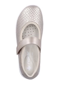 Light beige slip-on shoe with perforated upper, rounded toe, and adjustable strap. Features a soft interior and white sole.