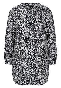 Blouse à manches longues, coupe ample, col arrondi, avec un motif noir et blanc. Le tissu est orné d'un design éclaboussé sur l'ensemble.