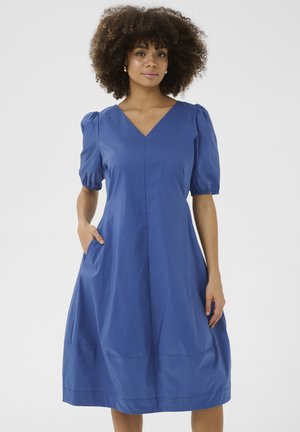 Blaues Baumwollkleid mit V-Ausschnitt, Puffärmeln und Seitentaschen. Das Design ist A-Linie, mit einer glatten Textur und einem einfachen Saum.