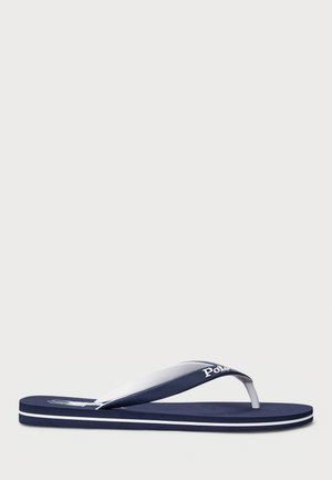 Navy blue flip-flop made of rubber, featuring a white strap and branding. The sole has a textured finish with contrasting white accents.