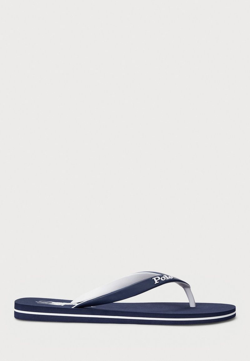 Navy blue flip-flop made of rubber, featuring a white strap and branding. The sole has a textured finish with contrasting white accents.
