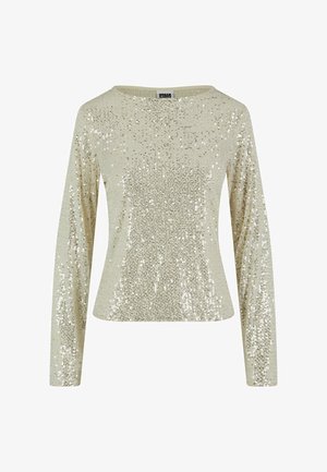 Haut à manches longues, col rond en beige clair orné de paillettes argentées éparpillées. Texture douce avec une silhouette ajustée et un léger éclat.