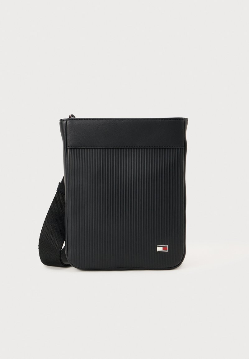 Black synthetic crossbody bag featuring a textured ribbed design, rectangular shape, adjustable strap, and branded logo detail on the front.