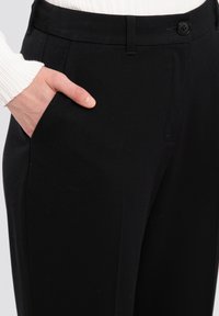 Black trousers featuring a sleek design, smooth texture, single pocket, and a button closure at the waist.