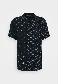 Kortärmad svart skjorta med delat mönster: ena sidan har diamantformer, den andra sidan har vågiga linjer, båda i vitt. Knappstängning.