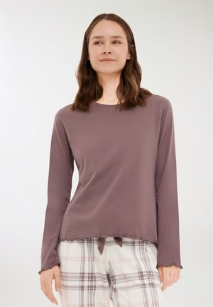 Maglietta a maniche lunghe in tessuto jersey mauve con scollatura rotonda e orlo irregolare, caratterizzata da bordi scallop e un dettaglio a fiocco nella parte inferiore.