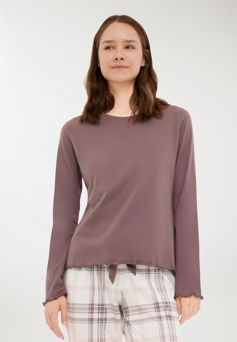 Długi rękaw top w mauve'owym dzianinie z okrągłym dekoltem i nierównym hemem, z falistymi brzegami i wiązaniem na dole.