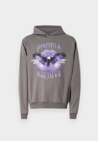 Felpa grigia con cappuccio caratterizzata da una stampa grafica di un'aquila e una luna in viola, con il testo "PHOBIA ARCHIVE" e dettagli dell'evento. Tessuto morbido, vestibilità regolare.
