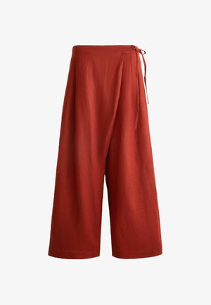 Wide-legged pants in textured rust fabric, featuring a high waist and side tie closure for adjustable fit.