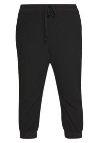 Czarne spodnie dresowe wykonane z miękkiego materiału, z elastycznym pasem i sznurkiem do regulacji. Posiadają ściągacze przy kostkach dla dopasowanego kroju.