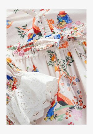 Kleid mit Blumenmuster aus leicht pinkfarbigem Stoff, elastischem Bund und weißen Spitzenakzenten an den Puffärmeln, verziert mit bunten Cartoonfiguren.