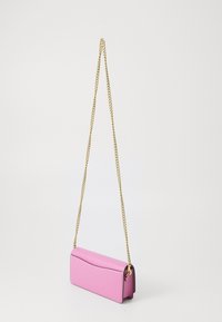 Pink leather handbag with a curved top, featuring a gold chain strap. The design is rectangular and smooth, with a minimalist aesthetic.