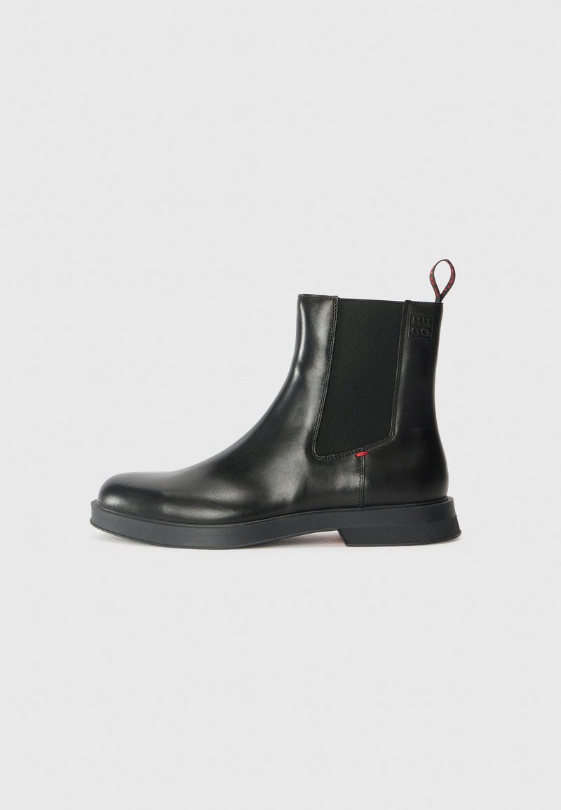 Black leather Chelsea boot with a smooth finish, elastic side panels, pull tab, and a thick rubber sole for traction and durability.
