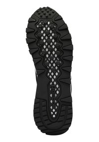 Sorte gummisole i svart med et teksturert mønster som har hevede knopper og diamantformer, designet for trekkraft og grep. Reebok-merket er synlig.