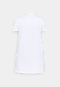 Witte katoenen t-shirt jurk met korte mouwen en een ronde halslijn, met een rechte snit en zijsplitten voor gemakkelijke beweging.