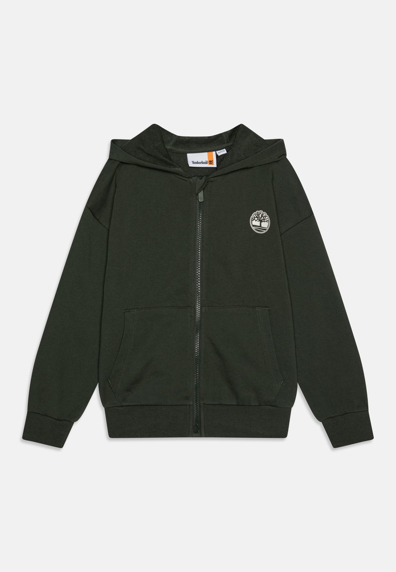 Tamsiai žalia užtrauktuku užsiseganti striukė, pagaminta iš minkštos medžiagos, su priekinėmis kišenėmis ir apvaliu logotipu kairėje krūtinės pusėje. Išplėsti rankogaliai ir apačia.