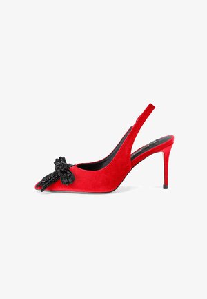 Décolleté slingback rossi in suede con punta affusolata, impreziositi da un fiocco di perline nere sulla tomaia. Tacco stiletto sottile e fodera interna nera.