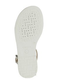 Suela de zapato de goma blanca con patrón perforado y marca "GEOX". Textura suave, forma redondeada y pequeños agujeros de drenaje para transpirabilidad.