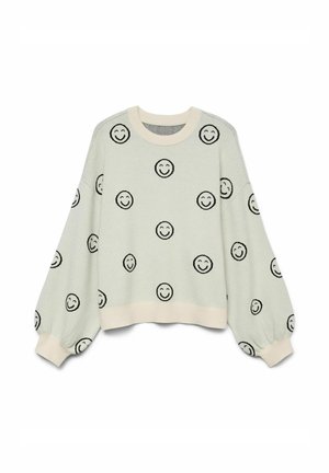 Sudadera verde claro con patrones de caras sonrientes negras. Presenta mangas sueltas y acampanadas, además de un cuello y un dobladillo en color crema con canalé.