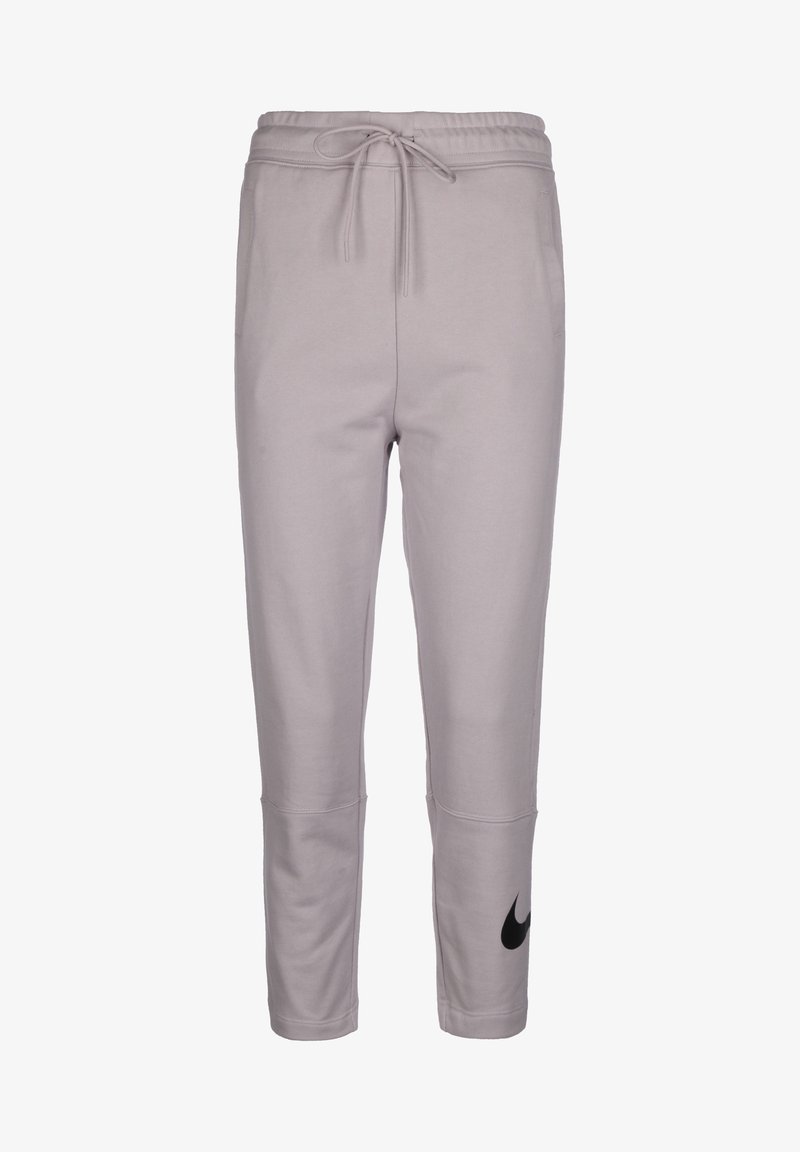 Pantalons de sudation gris clair en tissu doux, avec une taille à cordon, des jambes fuselées et un logo Nike noir sur le côté gauche.