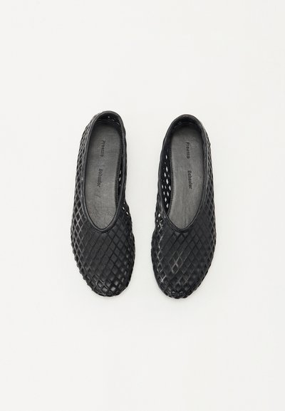 Black, lightweight slip-on shoes with a woven texture and diamond-patterned design. Flexible material, rounded toe, and open sides for breathability.