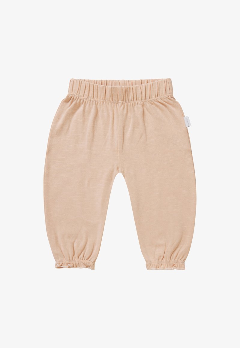 Spodnie w jasnym brzoskwiniowym kolorze, wykonane z miękkiego materiału. Posiadają elastyczny pas i elastyczne mankiety u kostek, co nadaje im zgromadzony wygląd.