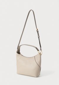 Beežika tekstuuriga nahast käekott lühikese sangaga ja reguleeritava pika rihmaga, millel on kuldse tooniga riistvara ja kaardus ülaäär.