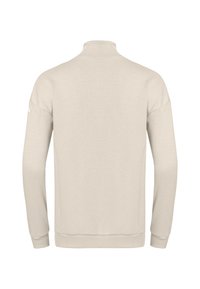 Pull beige clair avec un col montant, des manches longues, un tissu texturé arborant un motif en losange, et des bords côtelés aux poignets et à l'ourlet.