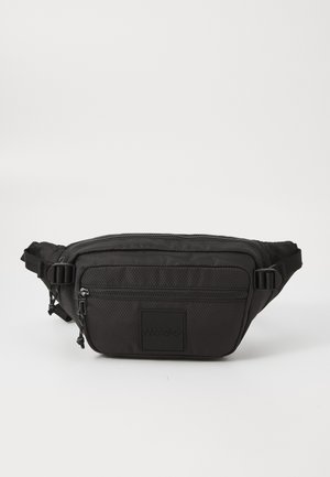 Black textured waist bag with two zippered compartments and adjustable side straps, featuring a square patch with embossed brand name.