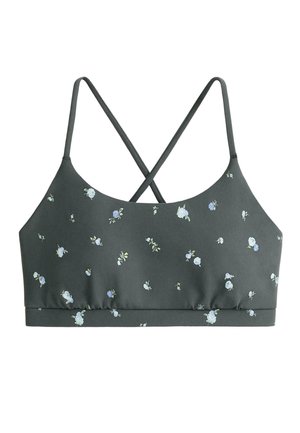 Donkergroene bralette met kleine witte en lichtblauwe bloemenprint, met dunne gekruiste schouderbandjes en een rechte elastische zoom.