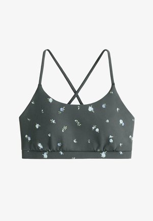 Donkergroene bralette met kleine witte en lichtblauwe bloemenprint, met dunne gekruiste schouderbandjes en een rechte elastische zoom.