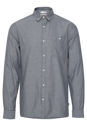 Striped button-up shirt in navy blue and white, featuring a collar, long sleeves, and a chest pocket with button detail. Cotton material.