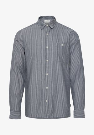 Chemise à rayures bleu marine et blanche, dotée d'un col, de manches longues et d'une poche poitrine avec un détail en bouton. Matériau en coton.