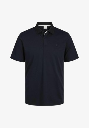 Tumesinine polo särk, mis on valmistatud puuvillast, kraega, lühikeste varrukatega ja millega on vasakul rindkere piirkonnas diskreetne logo. Sujuv tekstuur ja klassikaline sobivus.